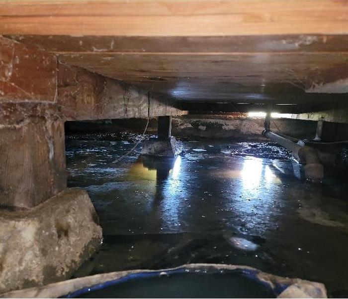 Crawl space flooded after rain.